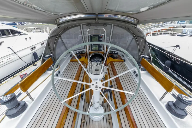 Slide: The Image of Farr 55 yacht cockpit, 1994 model, featuring a large steering wheel and navigation equipment. - 10