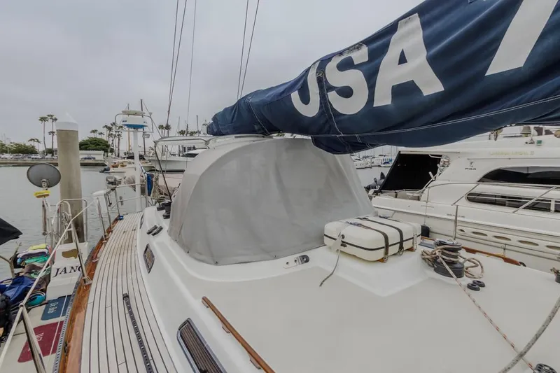 Slide: The Image of Farr 55 sailboat from 1994 docked in a marina, featuring a blue sail. - 24