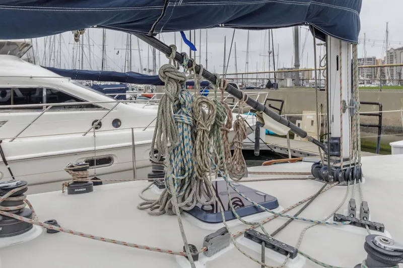 Slide: The Image of Sailboat deck with ropes and winches, Farr 55, 1994 model, docked in marina. - 26