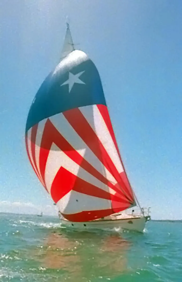 Slide: The Image of Sailing yacht Farr 55 (1994) with star-patterned spinnaker on open water. - 3