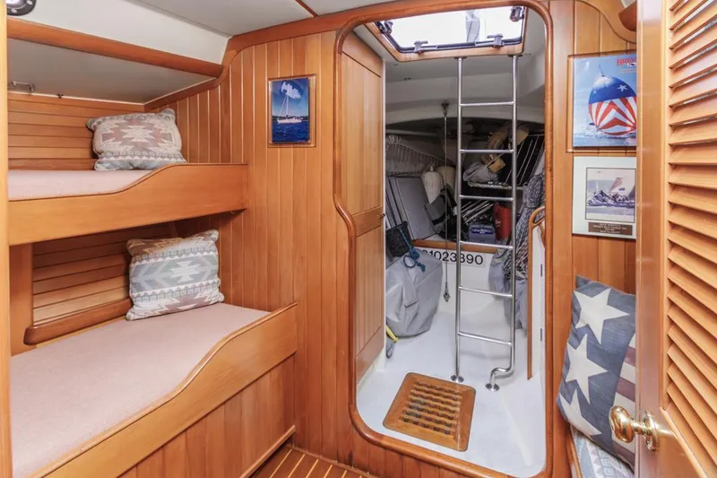 Slide: The Image of Cozy cabin interior of 1994 Farr 55 sailboat with wooden bunks and nautical decor. - 32
