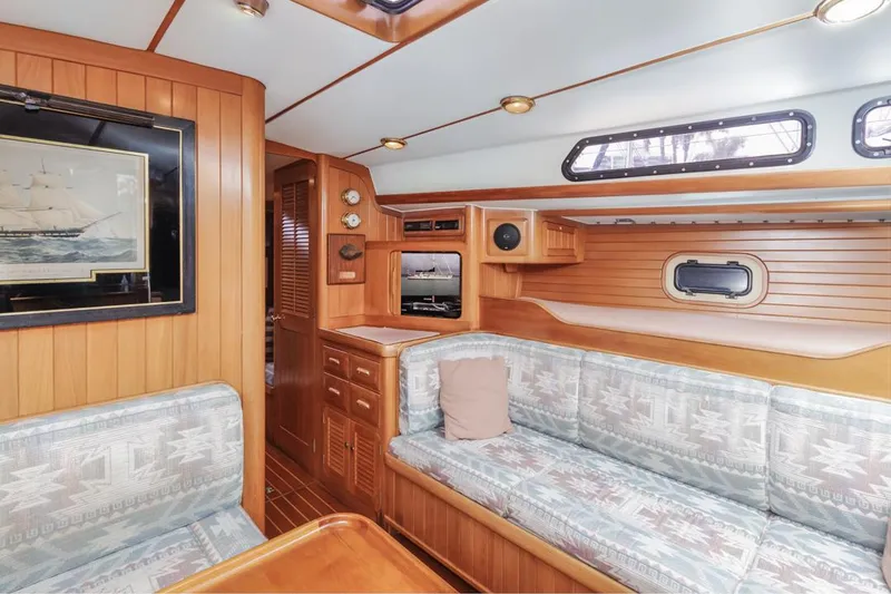 Slide: The Image of Interior of 1994 Farr 55 yacht with wood paneling and cozy seating area. - 35