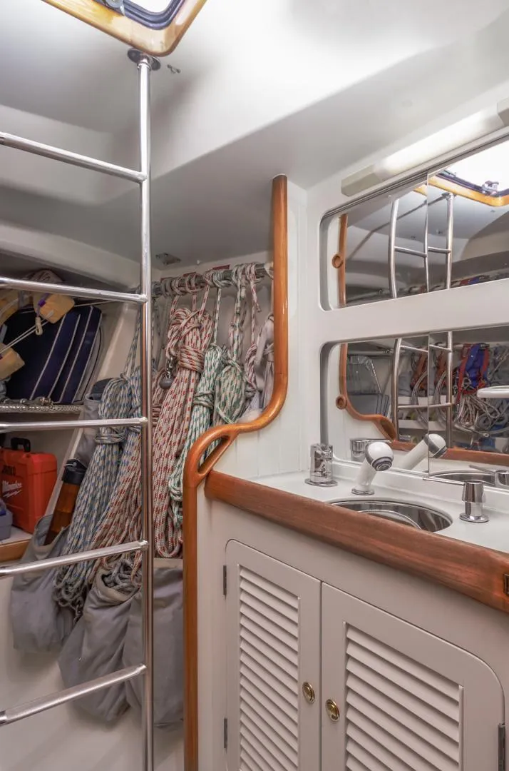 Slide: The Image of Interior of 1994 Farr 55 yacht with ropes, ladder, and sink area. - 38