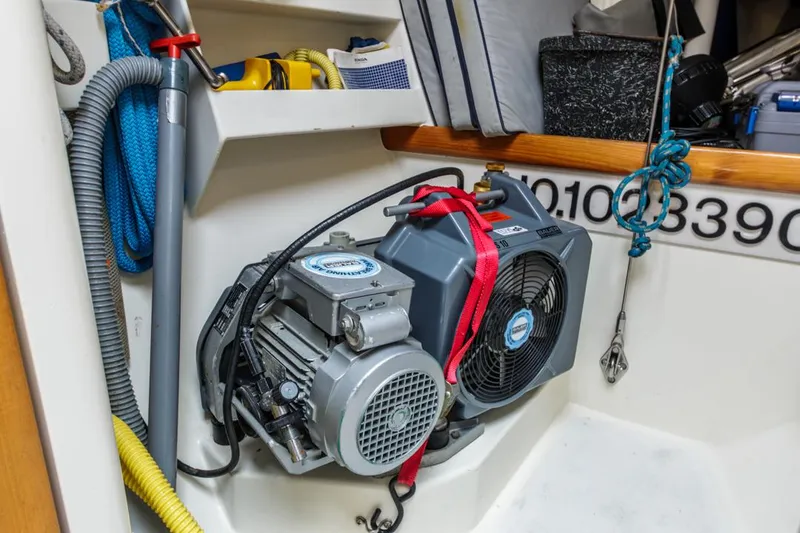 Slide: The Image of Engine compartment of a 1994 Farr 55 yacht, featuring equipment and storage. - 39