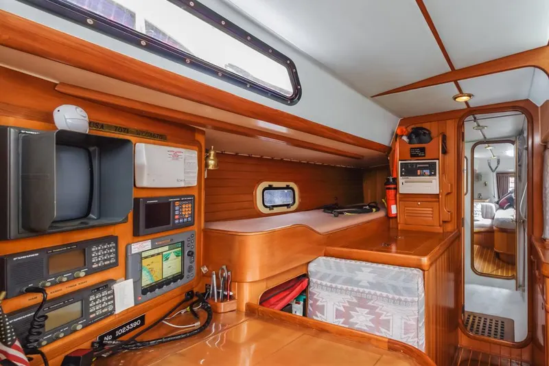 Slide: The Image of Interior of 1994 Farr 55 yacht with navigation equipment and wooden cabinetry. - 43