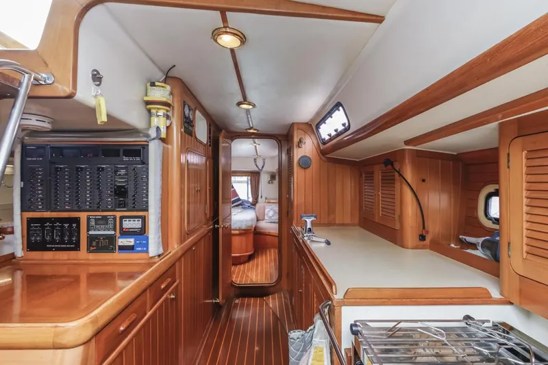 Slide: The Image of Interior of 1994 Farr 55 yacht with wood paneling and modern amenities. - 46