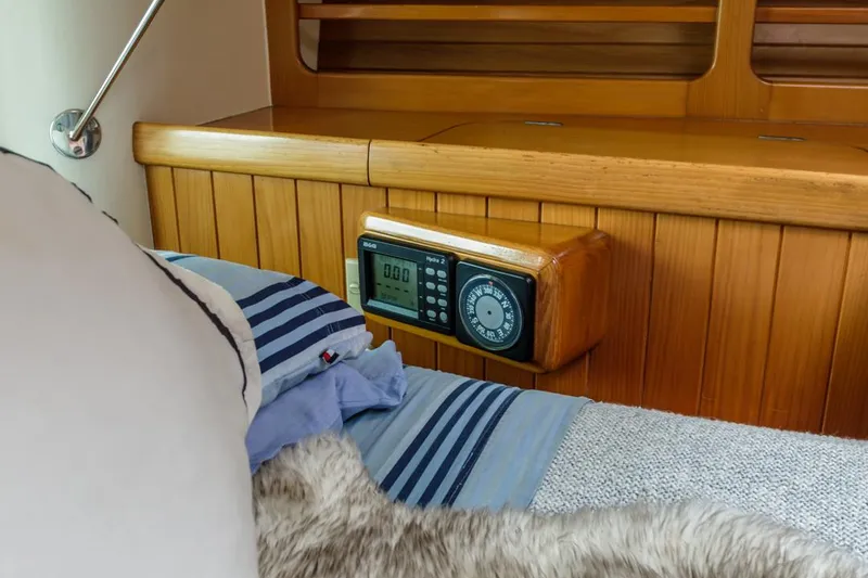 Slide: The Image of Cozy cabin interior of 1994 Farr 55 yacht with wooden paneling and bedding. - 49