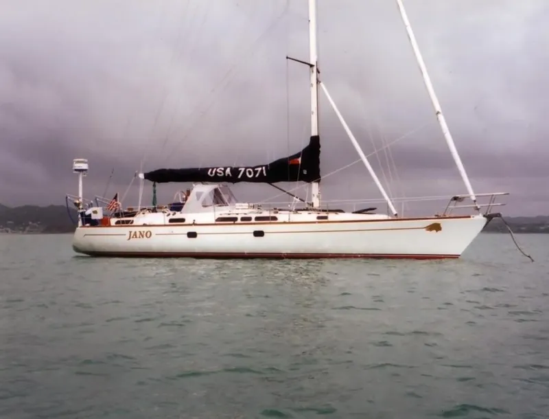 Slide: The Image of Sailing yacht Farr 55, 1994 model, named Jano on calm waters under cloudy skies. - 7