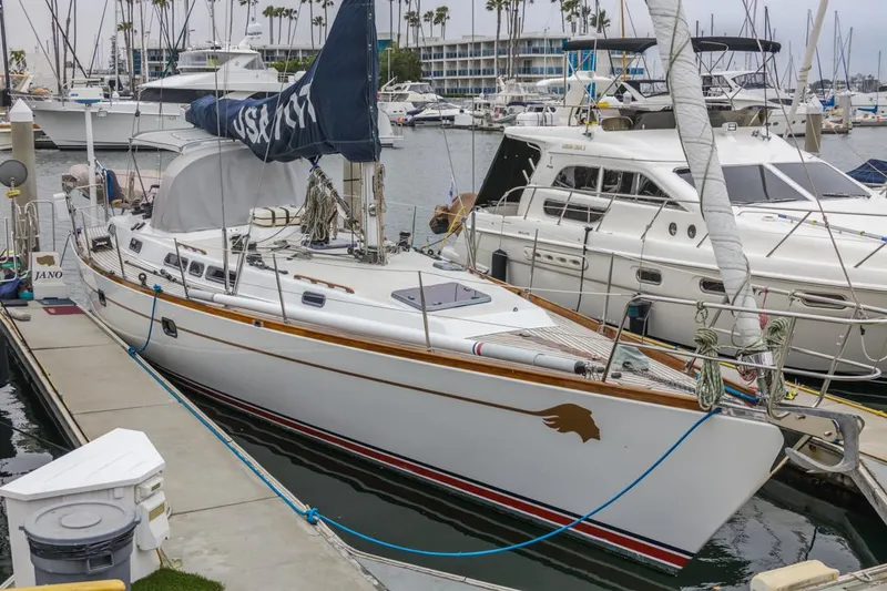 Slide: The Image of Farr 55 sailboat, 1994 model, docked in a marina with other boats. - 9