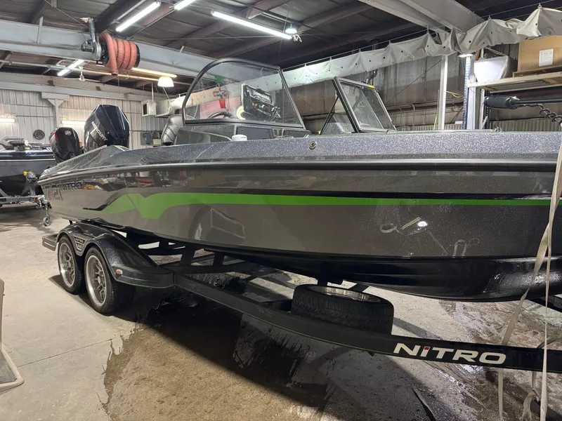 Slide: The Image of 2024 Nitro ZV21 Pro boat in a garage, featuring sleek design and green accents. - 3