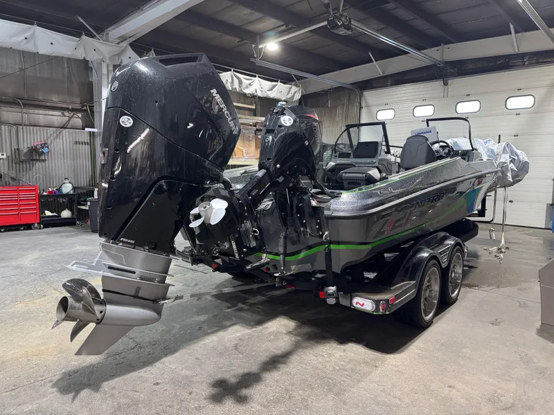 Slide: The Image of 2024 Nitro ZV21 Pro boat in a garage, featuring dual outboard motors. - 4