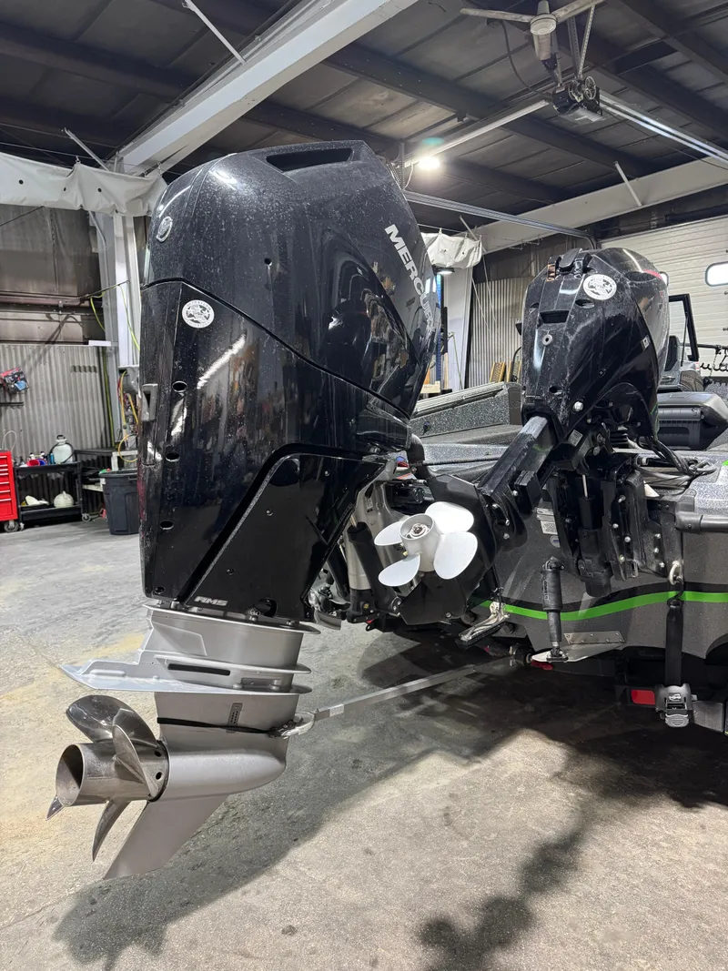 Slide: The Image of 2024 Nitro ZV21 Pro boat with dual outboard motors in a garage setting. - 6