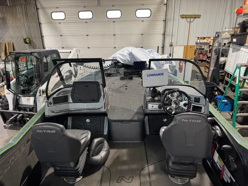 Slide: The Image of 2024 Nitro ZV21 Pro boat interior with dual seats and advanced navigation equipment. - 7