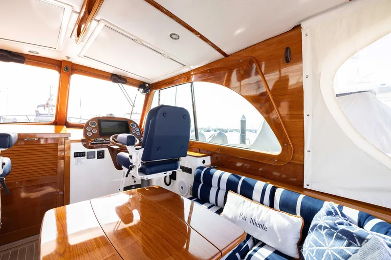 Slide: The Image of Interior of 2016 Hinckley 37 Picnic Boat with polished wood and nautical decor. - 17