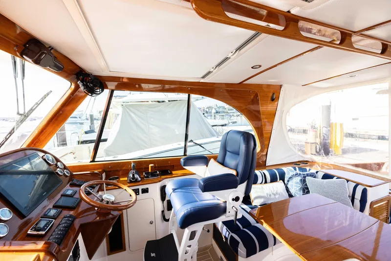 Slide: The Image of Interior of 2016 Hinckley 37 Picnic Boat with luxurious seating and polished wood finishes. - 18