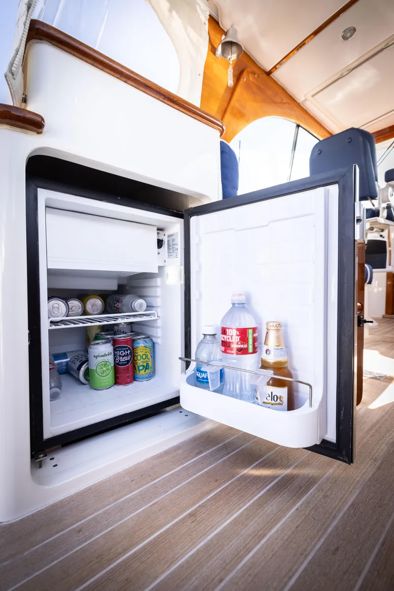 Slide: The Image of Mini fridge stocked with drinks on 2016 Hinckley 37 Picnic Boat. - 24