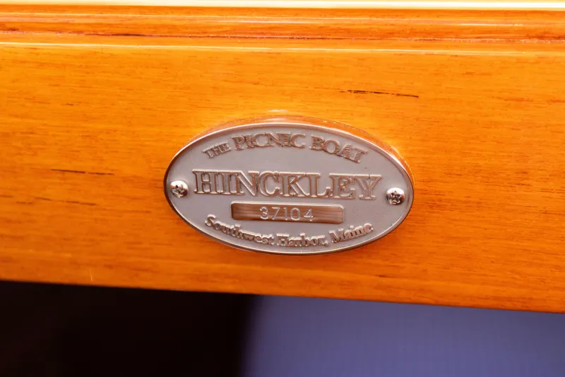 Slide: The Image of Hinckley 37 Picnic Boat 2016 nameplate on polished wood surface. - 25