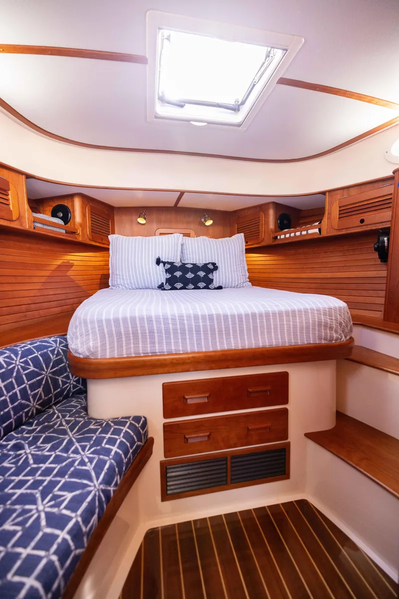 Slide: The Image of 2016 Hinckley 37 Picnic Boat cabin with cozy bed and elegant wood finish. - 30