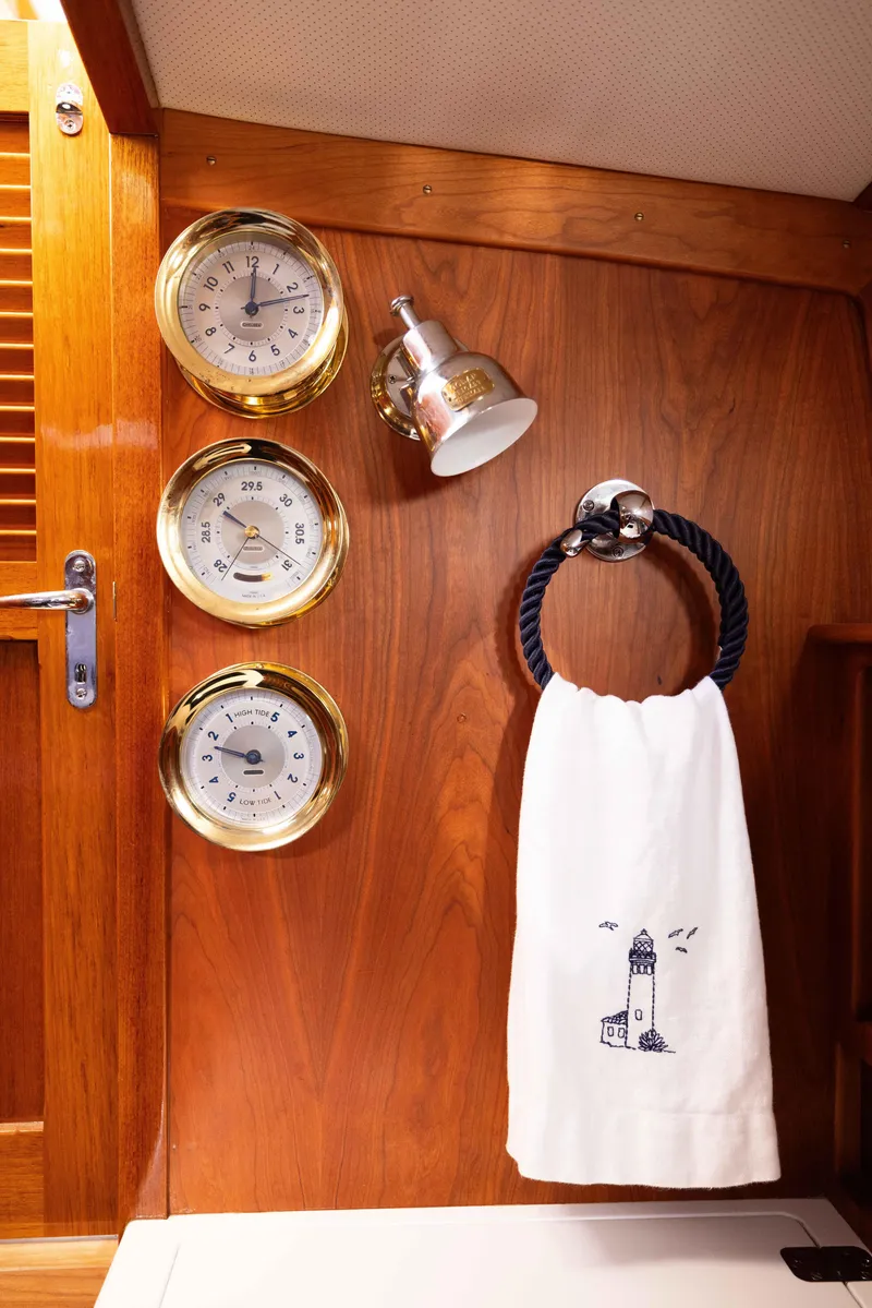 Slide: The Image of Hinckley 37 Picnic Boat 2016 interior with nautical instruments and lighthouse towel. - 34