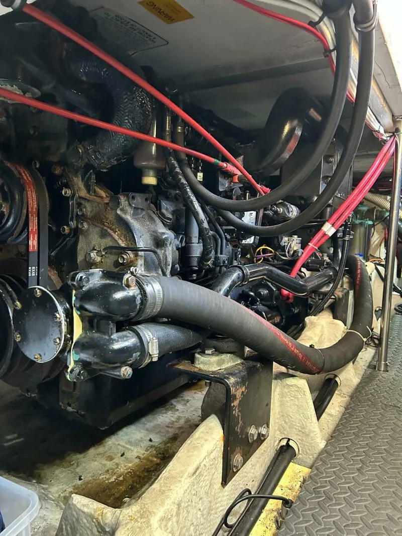 Slide: The Image of Engine room of a 1996 Bayliner 4788 Pilot House Motoryacht with visible hoses and components. - 13