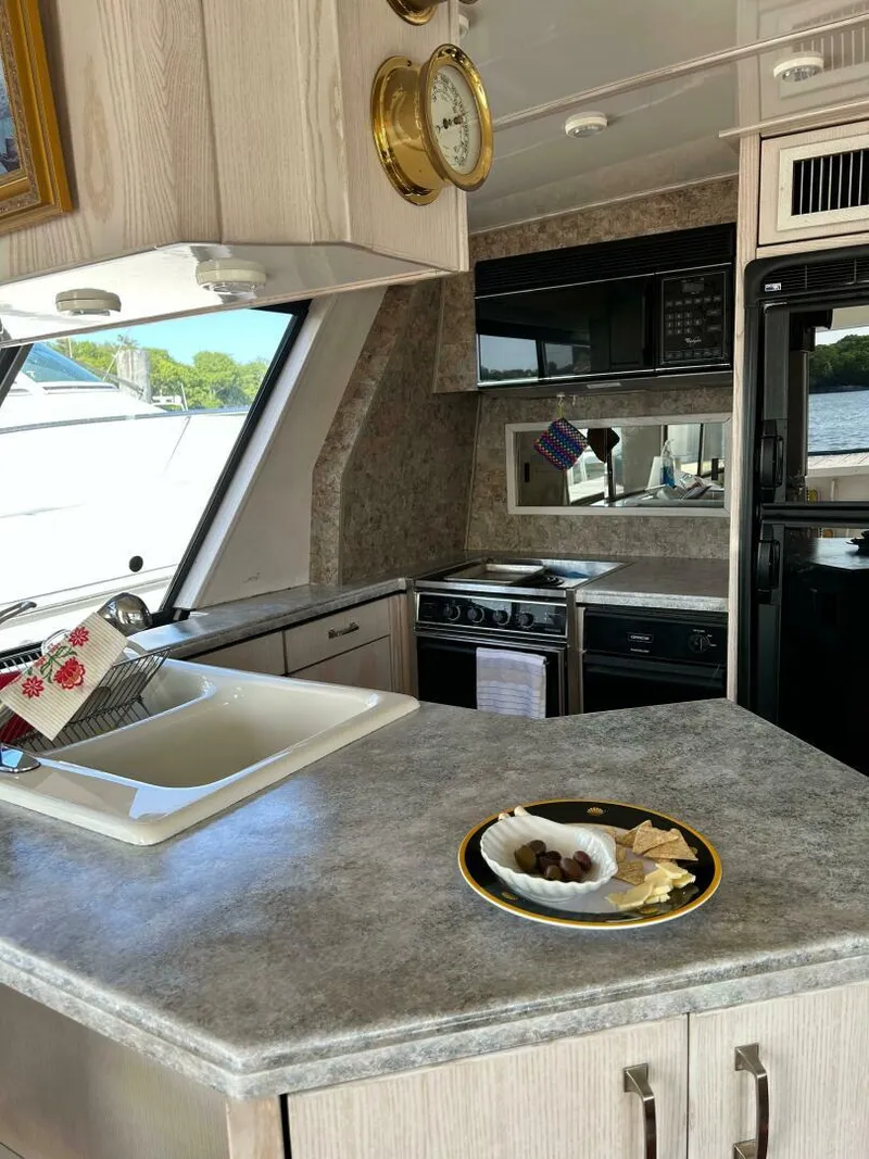 Slide: The Image of Interior of 1996 Bayliner 4788 Pilot House Motoryacht kitchen with modern appliances. - 15