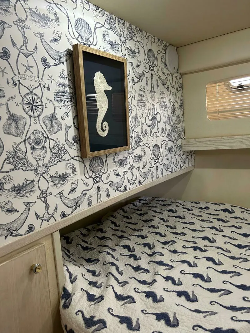 Slide: The Image of Nautical-themed bedroom in 1996 Bayliner 4788 Pilot House Motoryacht with seahorse decor. - 17