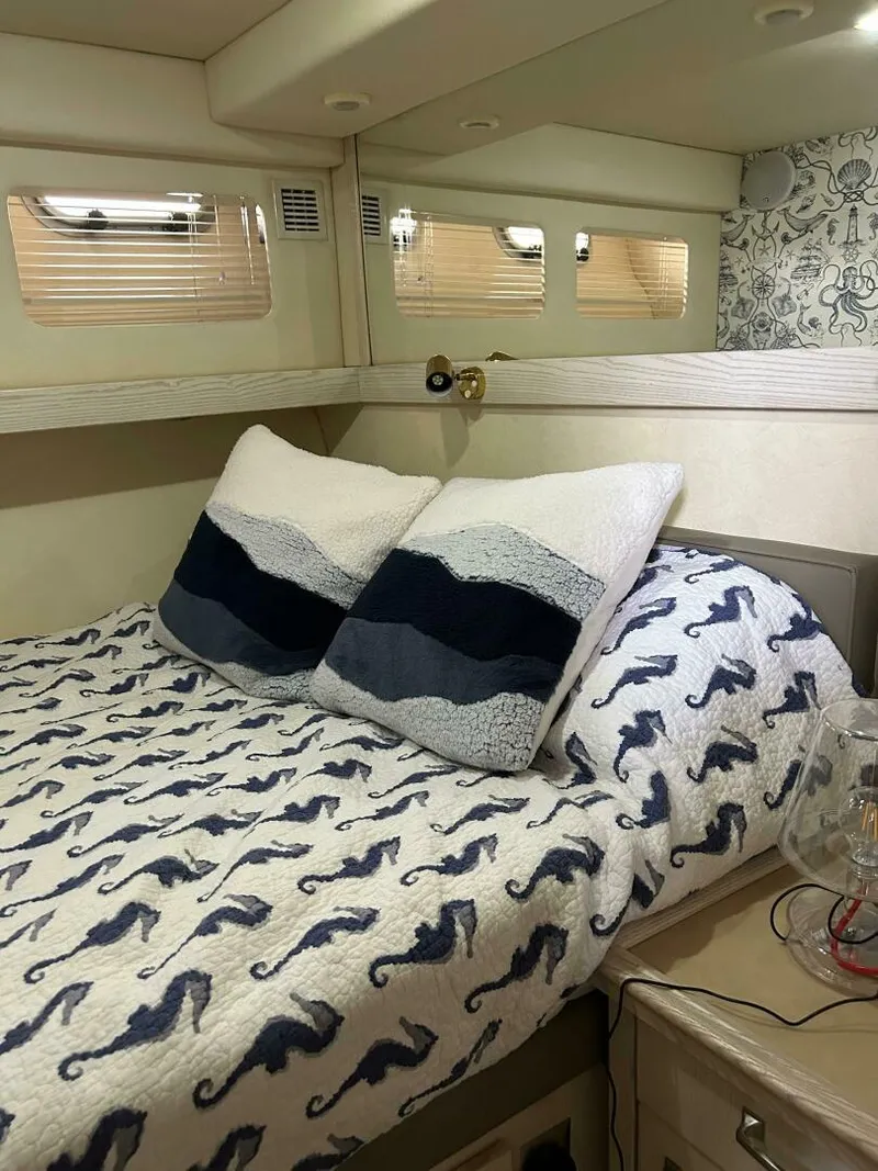 Slide: The Image of Cozy bedroom in 1996 Bayliner 4788 Pilot House Motoryacht with seahorse-themed bedding. - 18