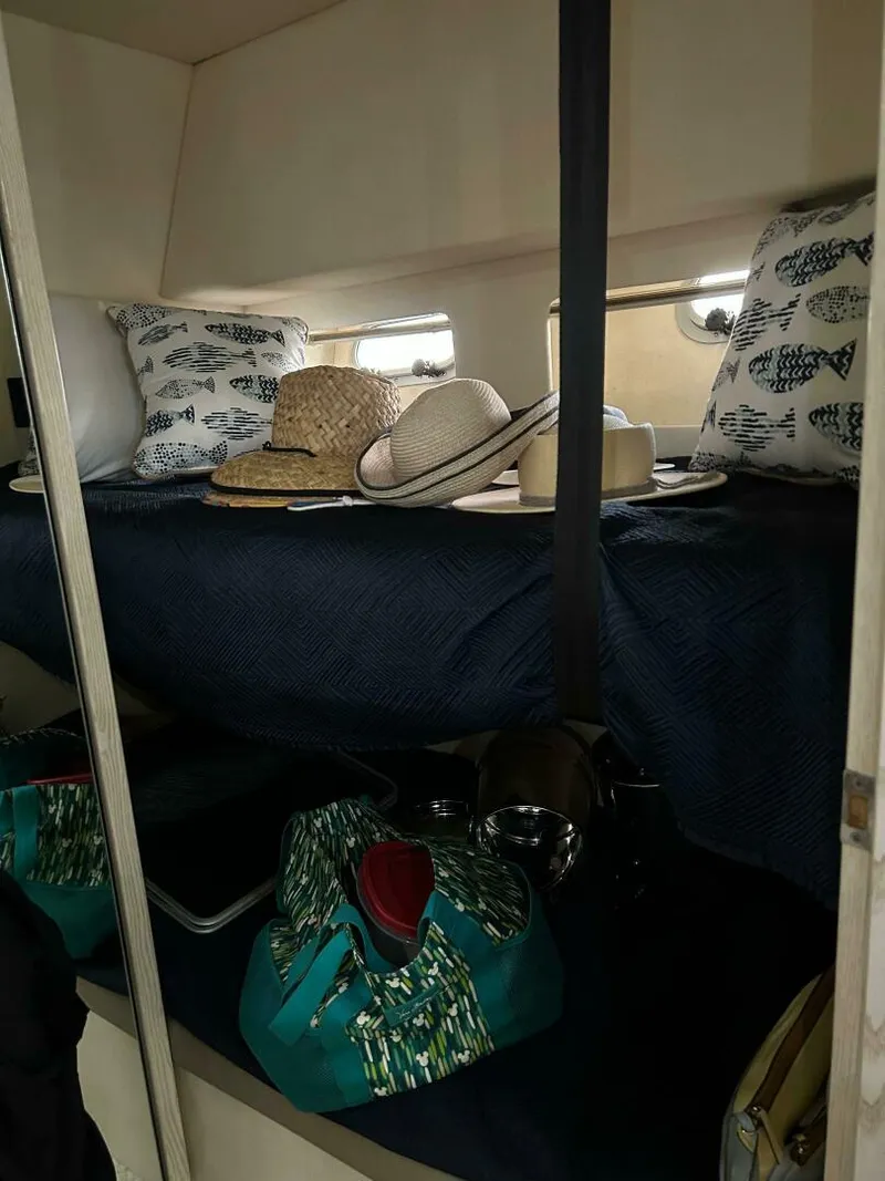 Slide: The Image of Cozy cabin interior of 1996 Bayliner 4788 Pilot House Motoryacht with pillows and hats. - 19