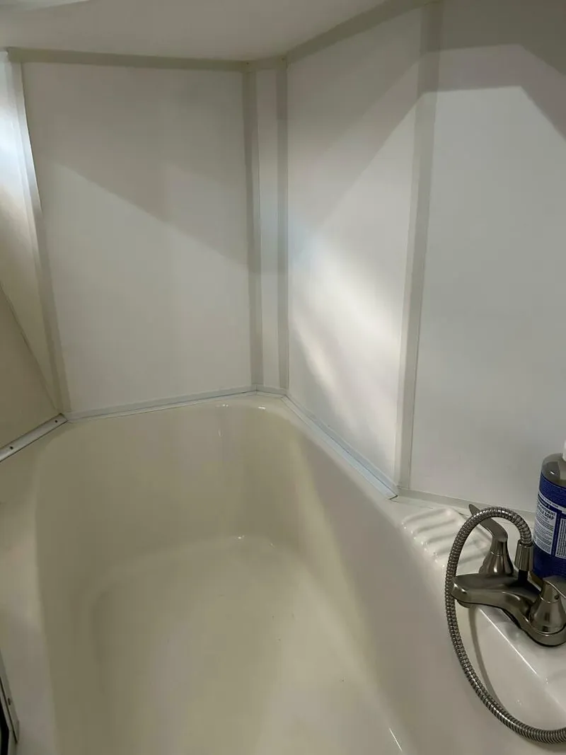Slide: The Image of Bathroom interior of 1996 Bayliner 4788 Pilot House Motoryacht, featuring a clean shower area. - 20