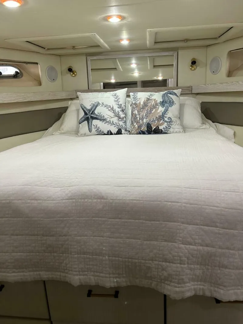 Slide: The Image of Cozy bedroom in 1996 Bayliner 4788 Pilot House Motoryacht with nautical-themed pillows. - 22