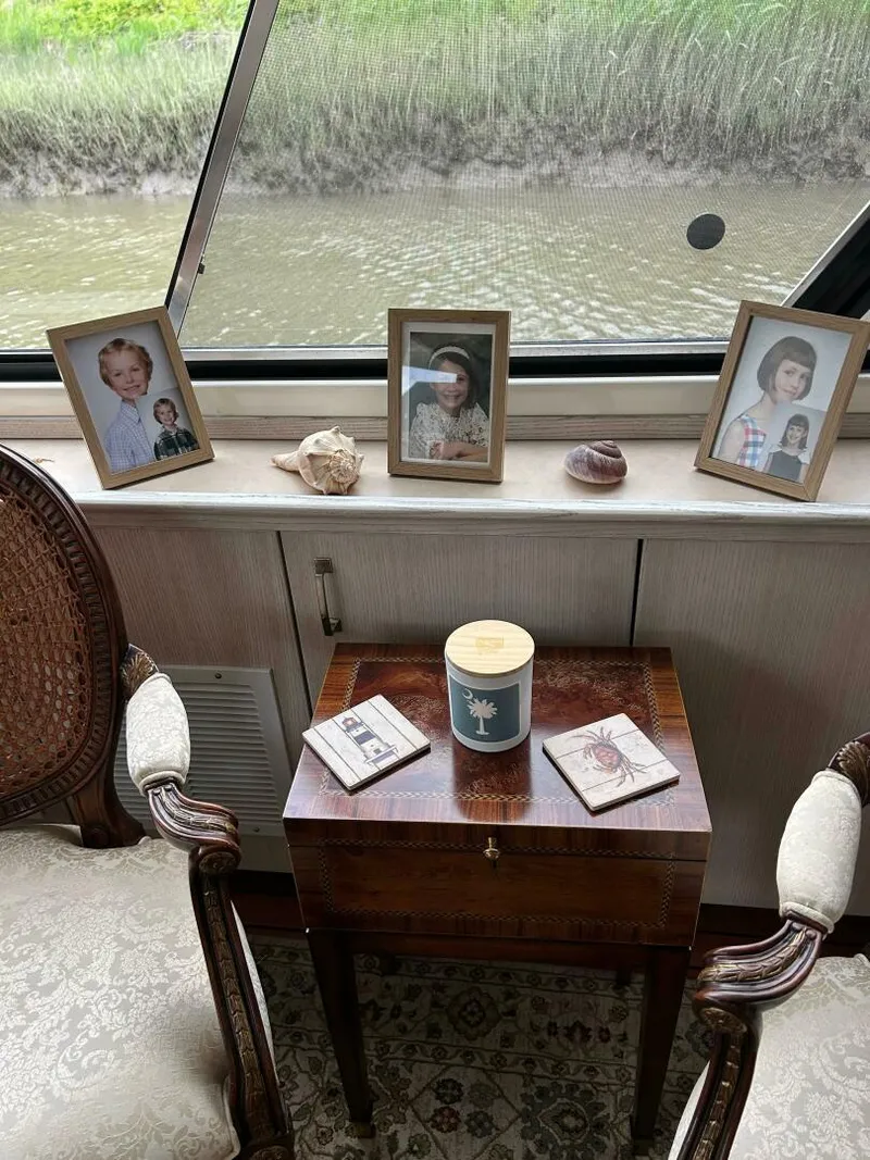 Slide: The Image of Interior of 1996 Bayliner 4788 Pilot House Motoryacht with framed photos and decor. - 24