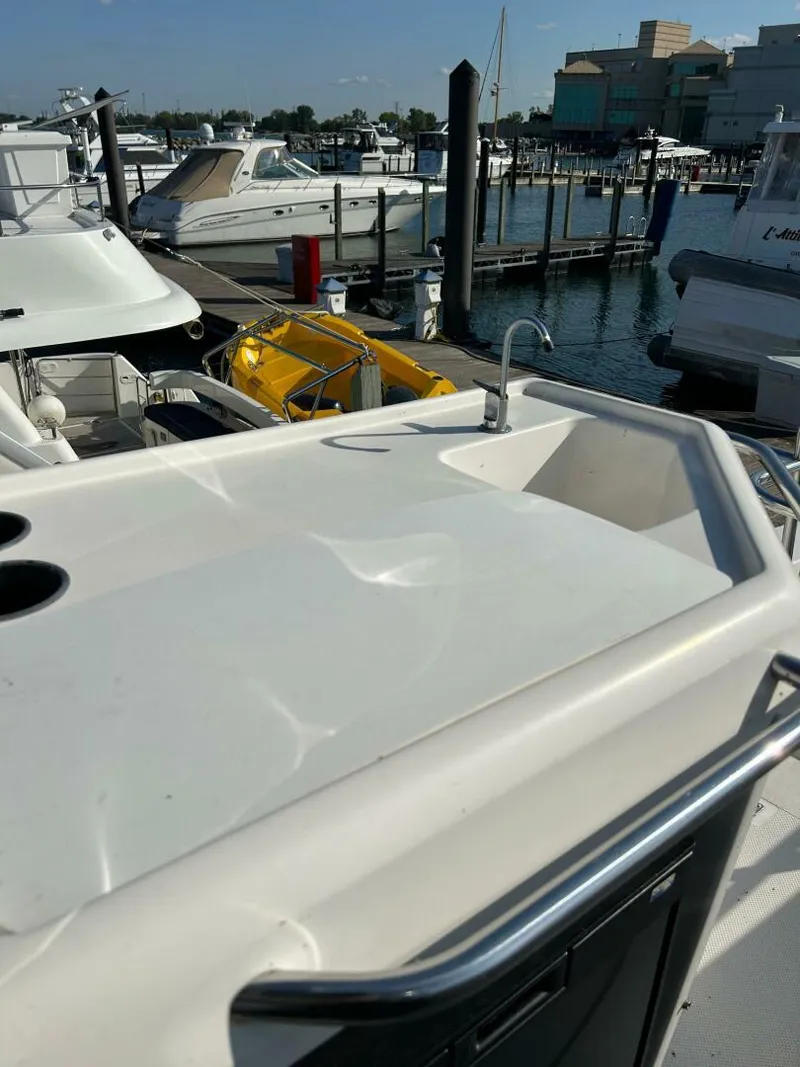 Slide: The Image of 1996 Bayliner 4788 Pilot House Motoryacht docked at marina, featuring deck and railing. - 28
