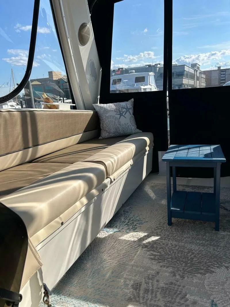 Slide: The Image of Interior of 1996 Bayliner 4788 Pilot House Motoryacht with cushioned seating and small table. - 29