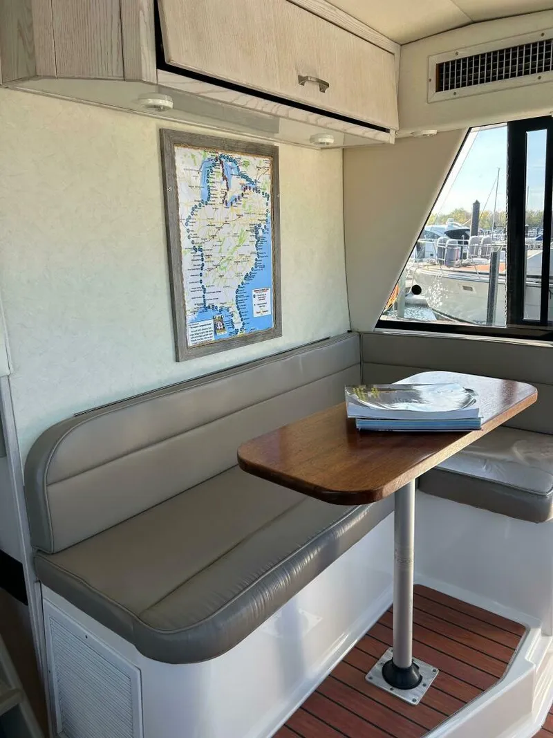 Slide: The Image of 1996 Bayliner 4788 Pilot House Motoryacht interior with map, table, and seating area. - 31