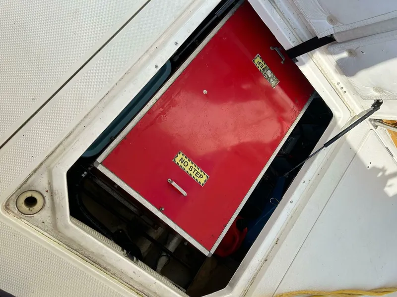 Slide: The Image of Engine compartment of 1996 Bayliner 4788 Pilot House Motoryacht with red cover and "No Step" sign. - 9