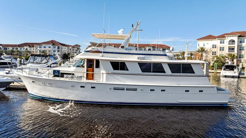 Slide: The Image of 1987 Hatteras 68 Cockpit Motor Yacht docked in marina, clear blue sky. - 0