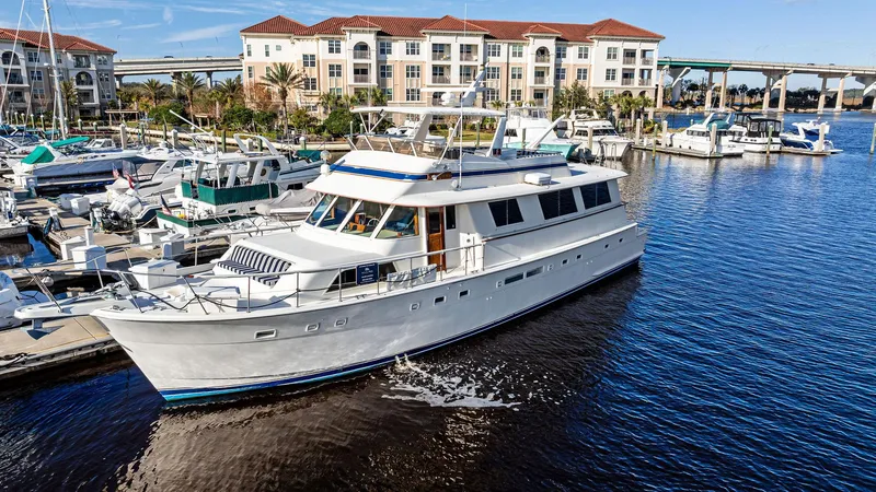 Slide: The Image of 1987 Hatteras 68 Cockpit Motor Yacht docked in marina, sunny day. - 1