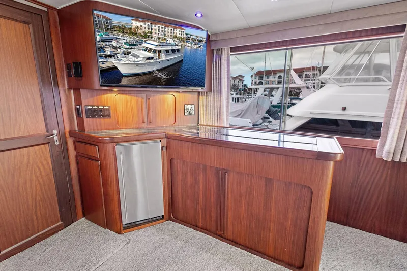 Slide: The Image of Interior of 1987 Hatteras 68 Cockpit Motor Yacht with wood cabinetry and large window view. - 19