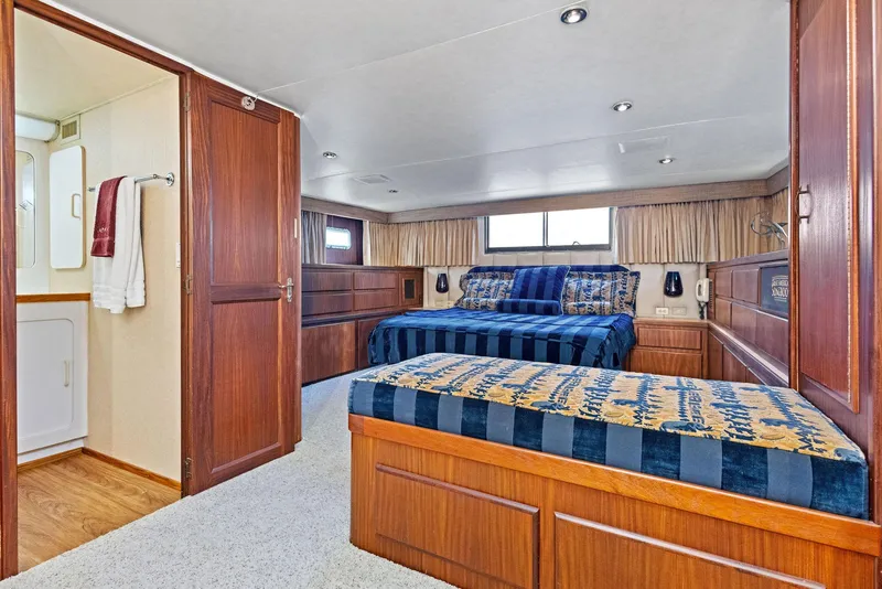 Slide: The Image of Luxurious bedroom in 1987 Hatteras 68 Cockpit Motor Yacht with elegant wood finishes. - 26