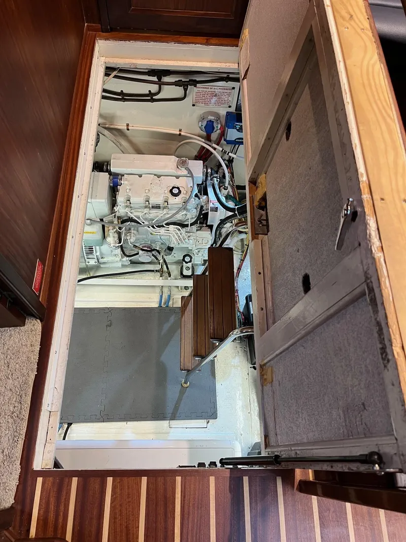 Slide: The Image of Engine room of 1987 Hatteras 68 Cockpit Motor Yacht, showcasing mechanical components. - 37