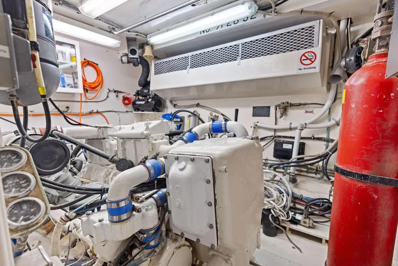 Slide: The Image of Engine room of 1987 Hatteras 68 Cockpit Motor Yacht with machinery and gauges. - 39