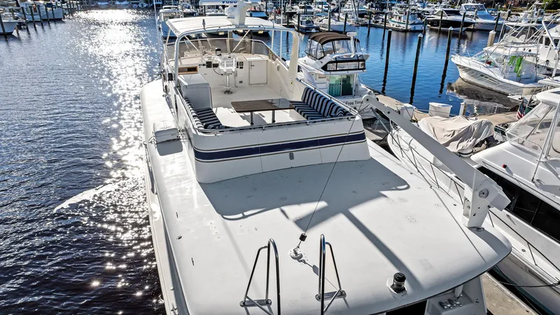 Slide: The Image of 1987 Hatteras 68 Cockpit Motor Yacht docked at marina, sunny day. - 4