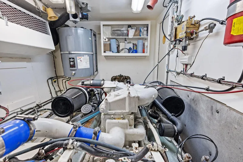 Slide: The Image of Engine room of 1987 Hatteras 68 Cockpit Motor Yacht, showcasing mechanical components and equipment. - 40