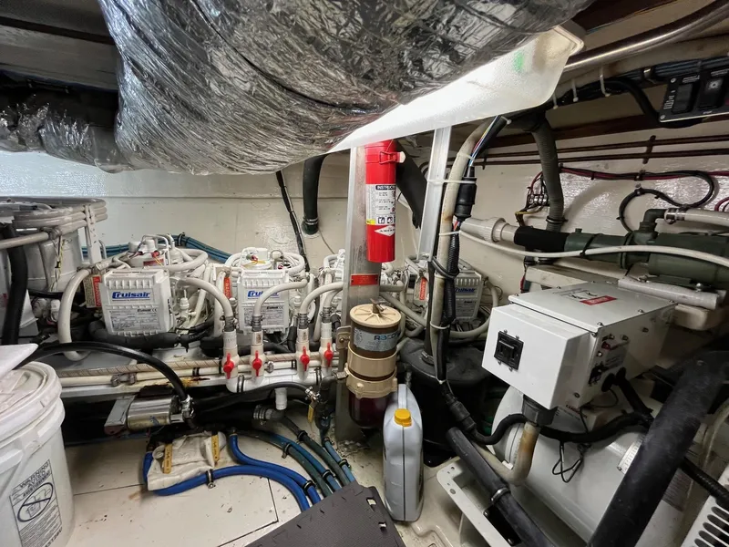 Slide: The Image of Engine room of 1987 Hatteras 68 Cockpit Motor Yacht with mechanical equipment and wiring. - 42