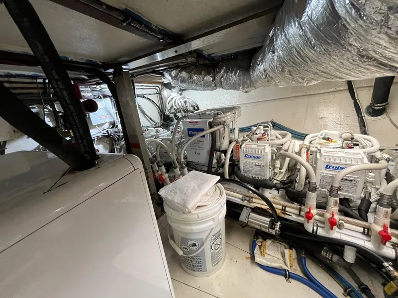 Slide: The Image of Engine room of 1987 Hatteras 68 Cockpit Motor Yacht with mechanical equipment and piping. - 43