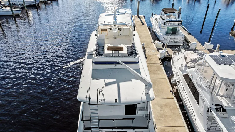Slide: The Image of 1987 Hatteras 68 Cockpit Motor Yacht docked at marina, aerial view. - 5