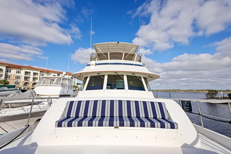 Slide: The Image of 1987 Hatteras 68 Cockpit Motor Yacht docked under blue sky. - 7