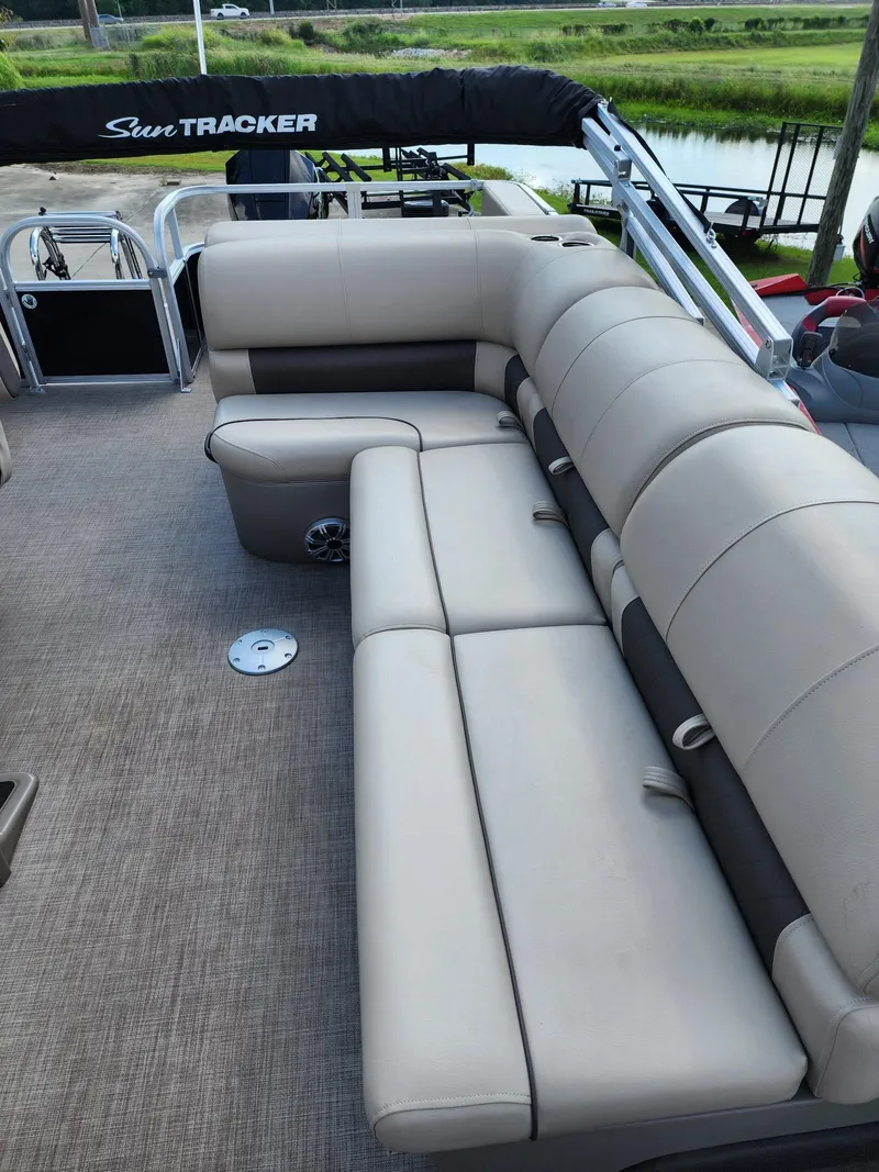 Slide: The Image of 2023 Sun Tracker SF24 pontoon boat with spacious seating and sleek design. - 10