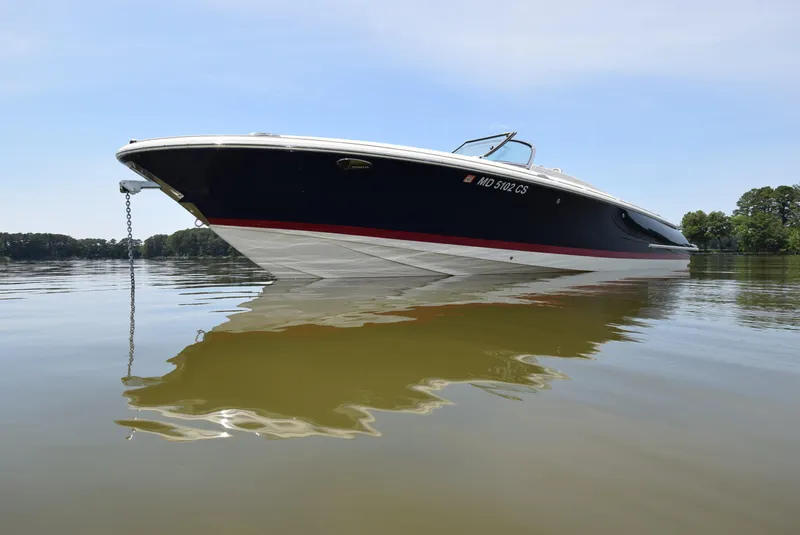 Slide: The Image of 2017 Chris-Craft Launch 25 boat on calm water, side view. - 10