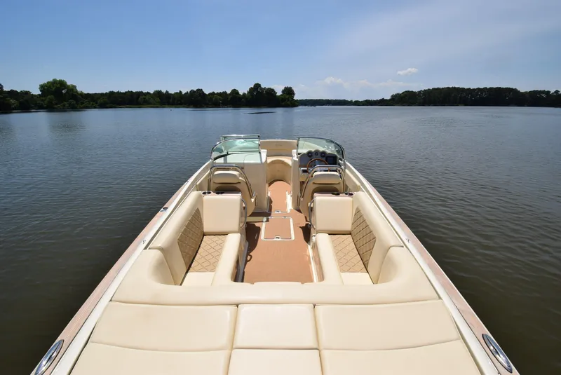 Slide: The Image of 2017 Chris-Craft Launch 25 boat on calm lake, featuring luxurious seating and sleek design. - 11